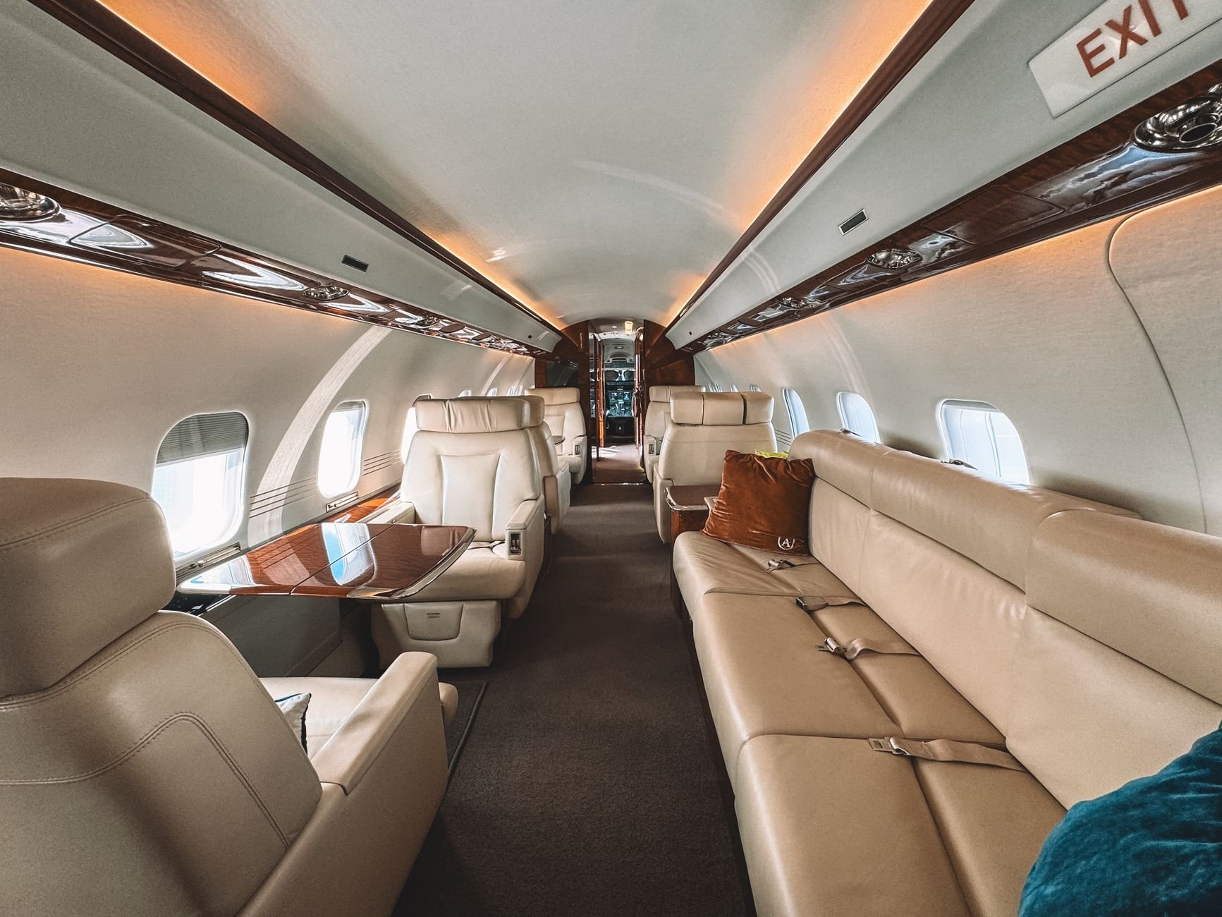 Luxury private jet cabin with leather seats and wooden trim